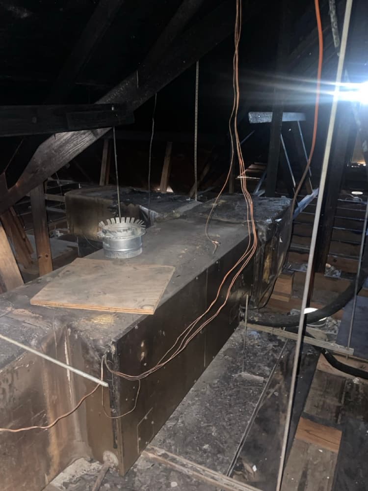 Technician cleaning AC condenser coil outdoors