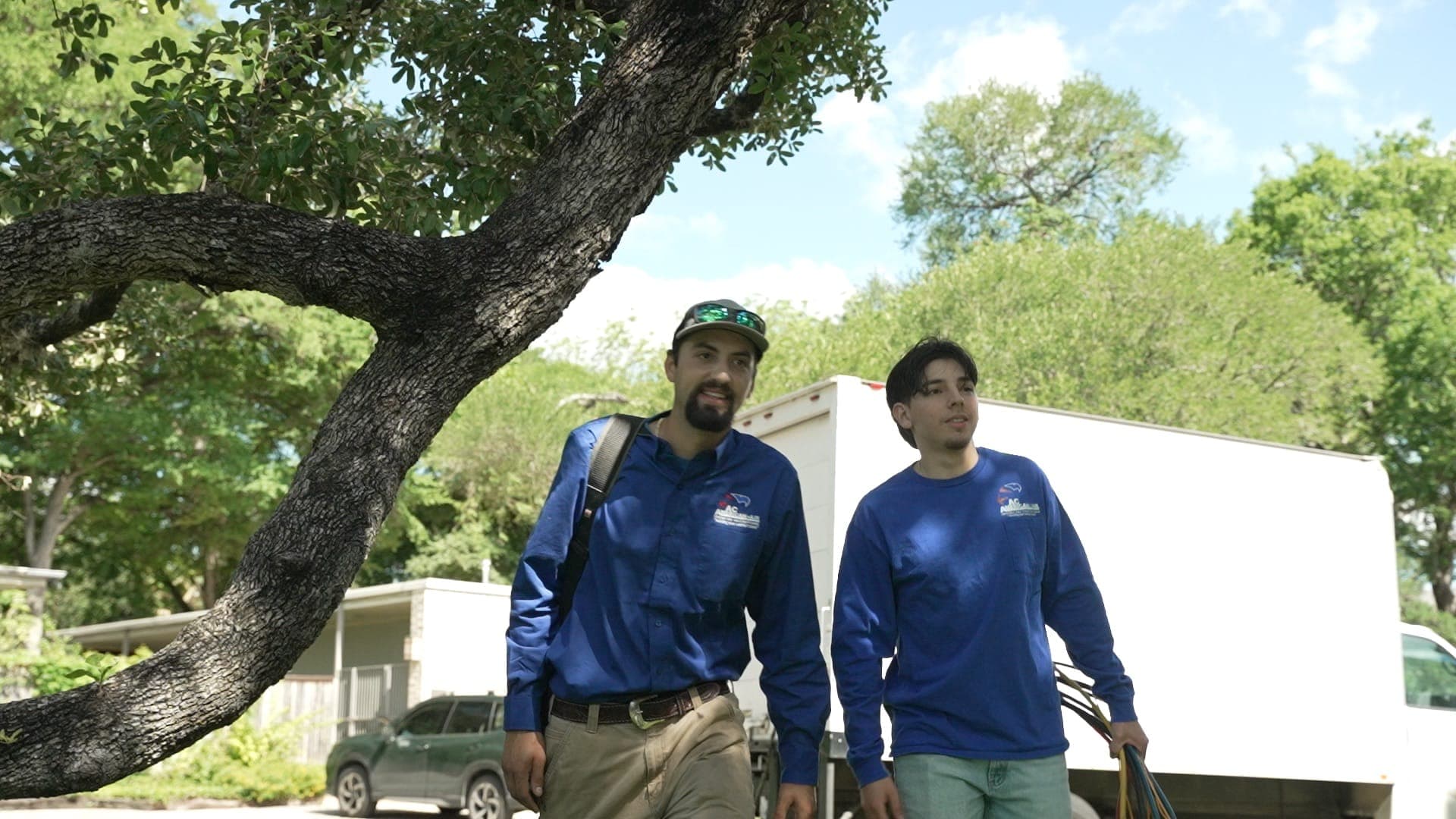 HVAC technicians walking to a job site in San Antonio