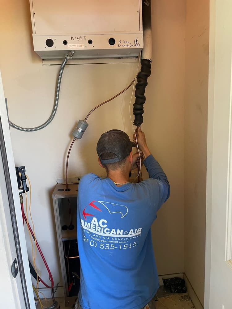 AC American Air technician installing air handler in closet at San Antonio home