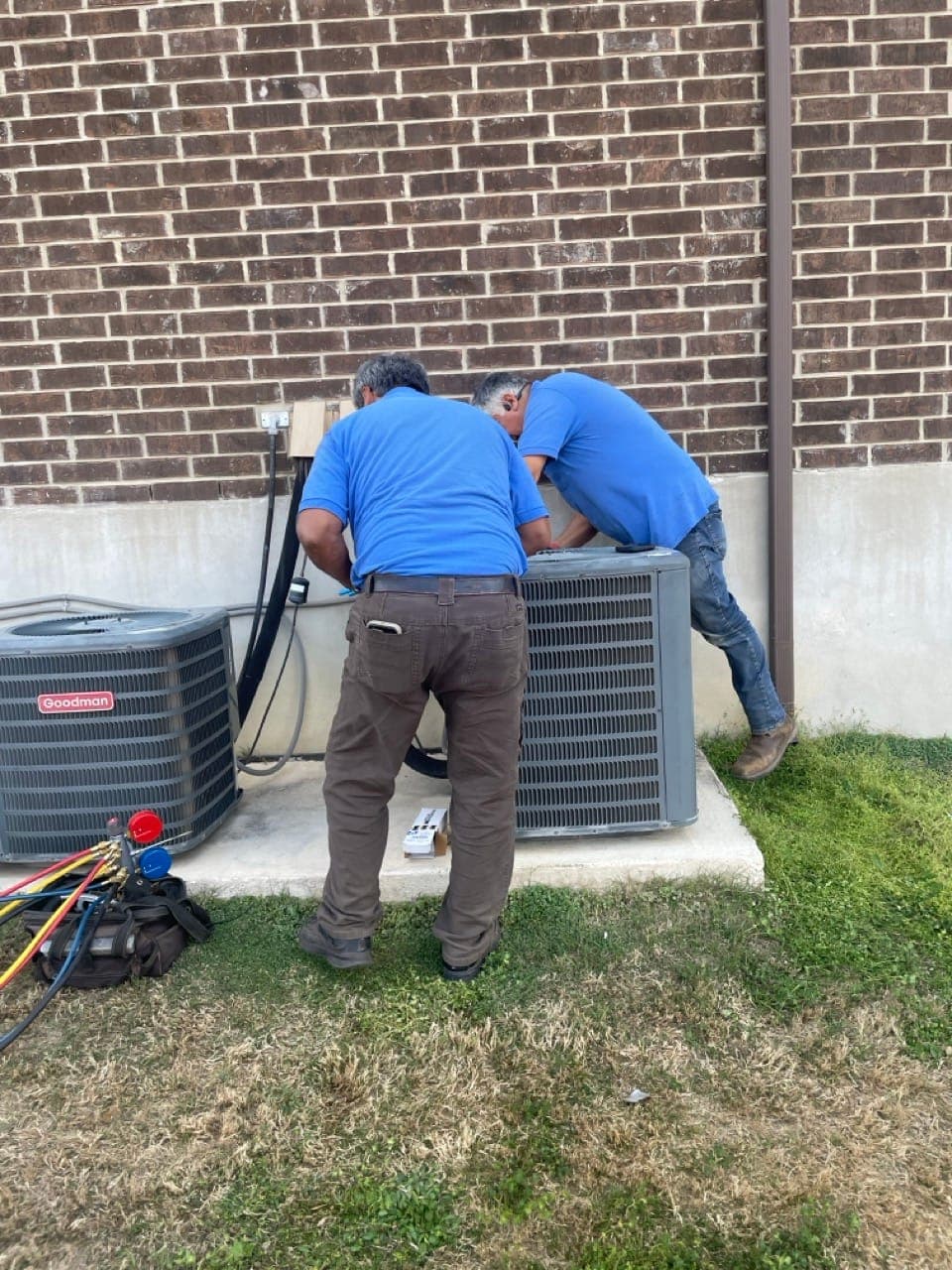 AC technician diagnosing unit in Converse