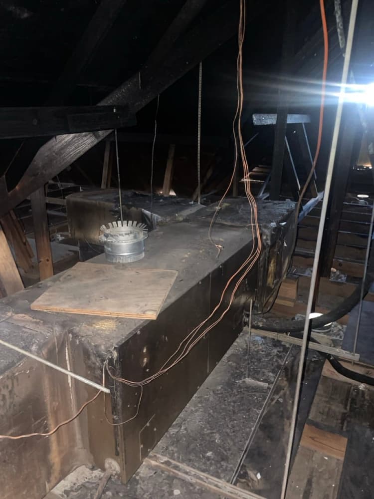 Technician cleaning AC condenser coil outdoors