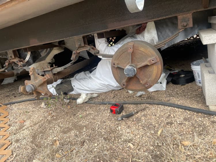 HVAC technician repairing blower motor in crawlspace for heating system in San Antonio