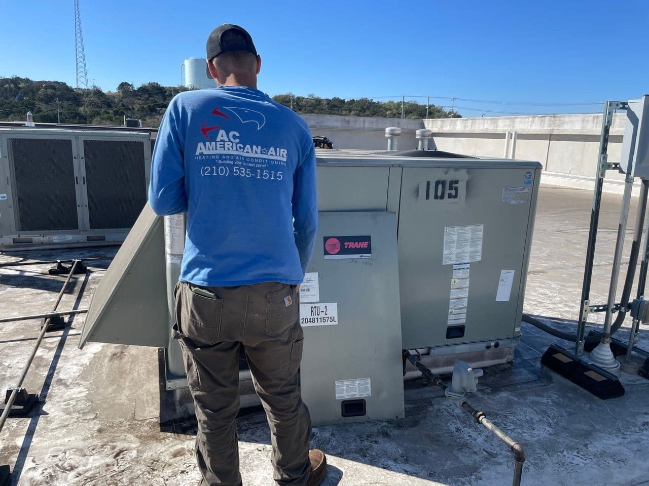 AC technician performing seasonal HVAC maintenance